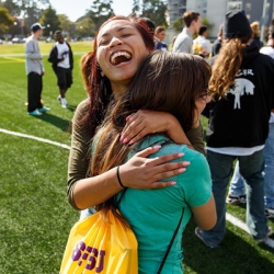 Two Females hugging and laughing